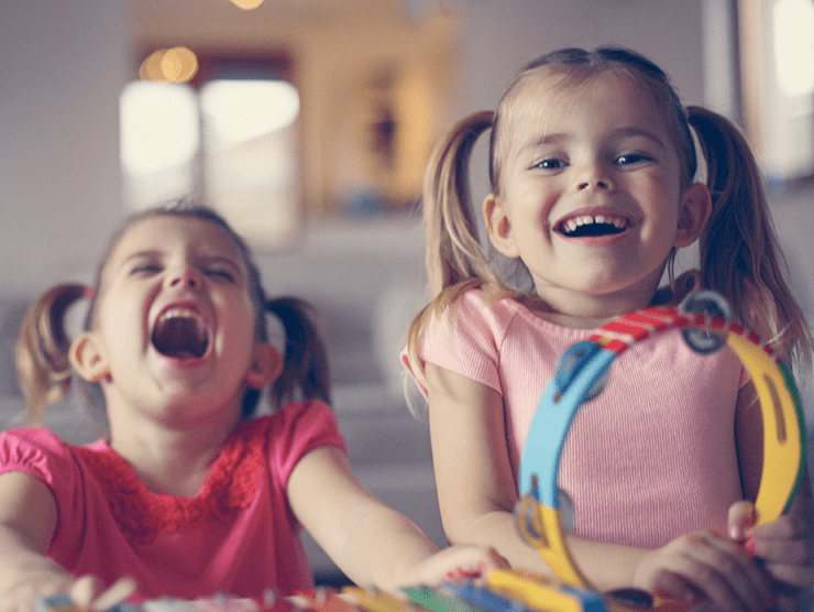 Two toddlers laughing