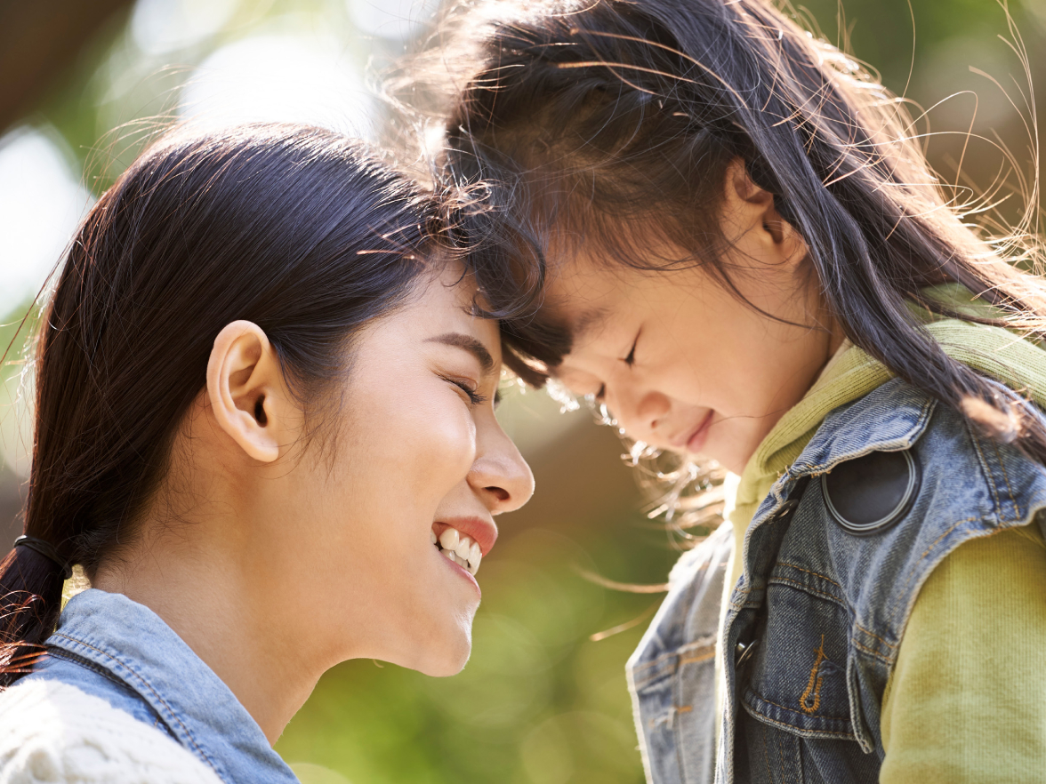 Asian american mother and daughter smiling