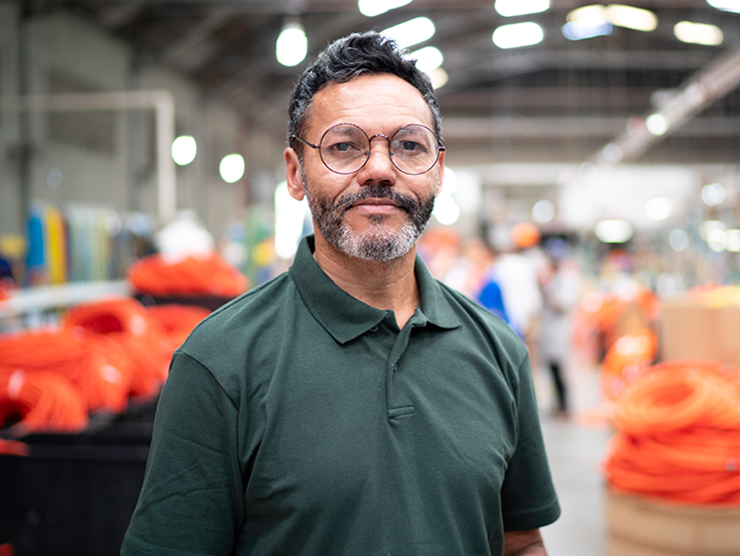 Hispanic employee happy at his job due to education benefits