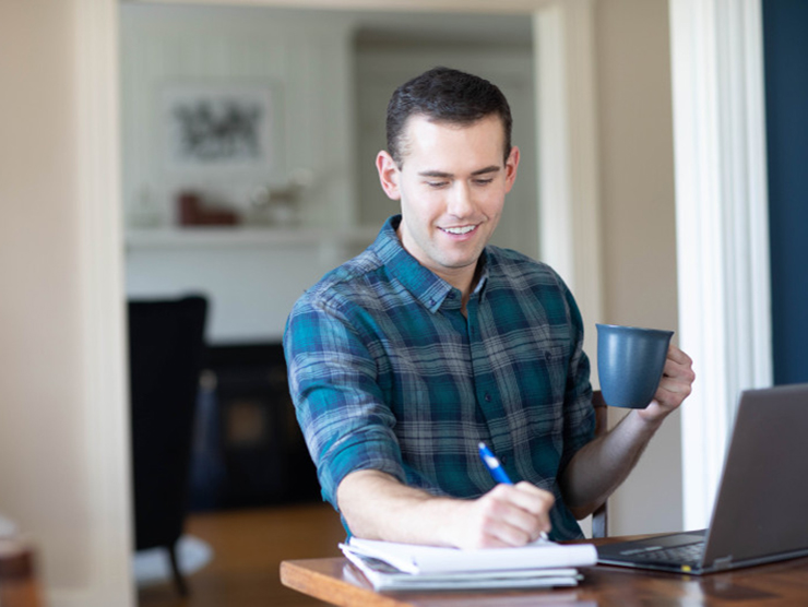 Adult learner at home happy that the student loan pause was extended