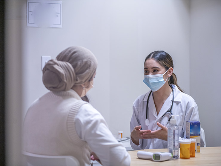 Female nurse practitioner consulting with a female patient