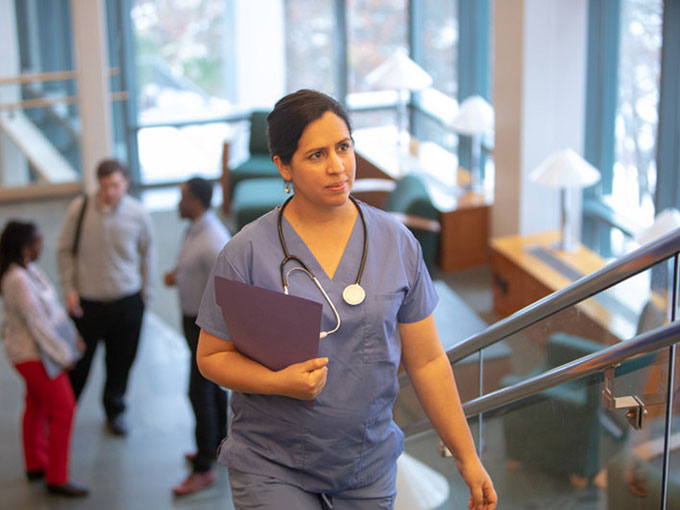 Nurse walking up the stairs in a hospital