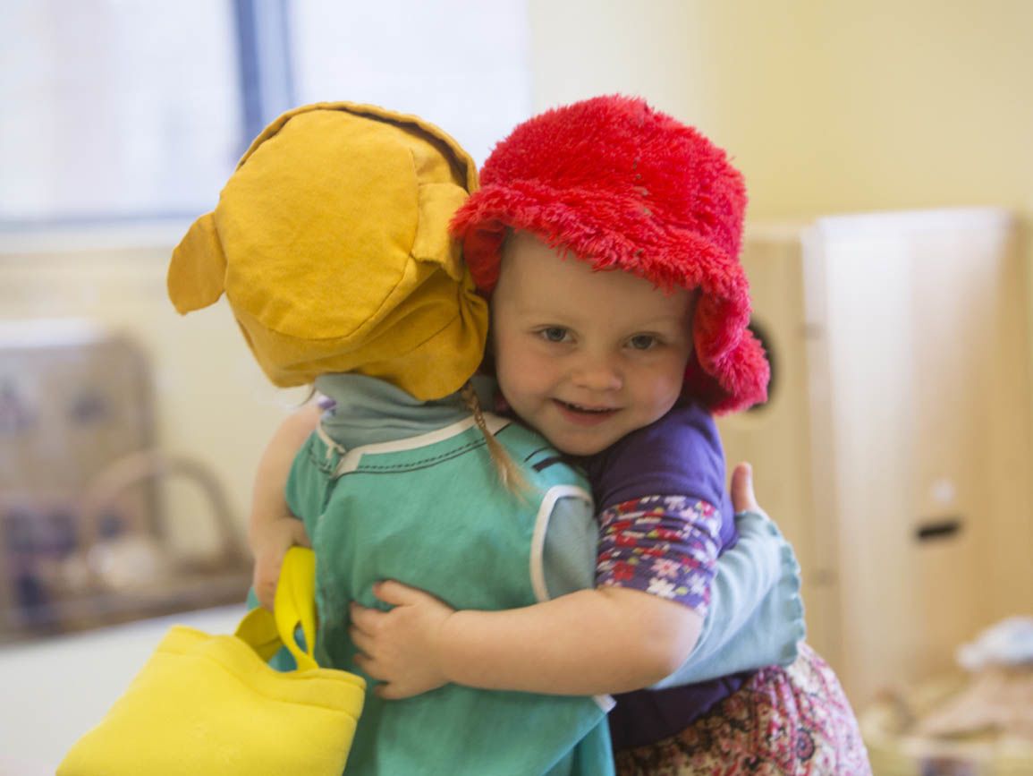 Two young toddlers hugging