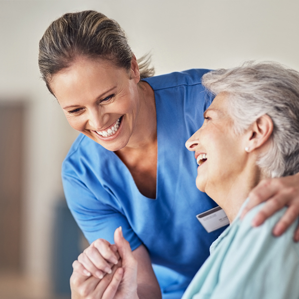 Healthcare work smiling with elder patient