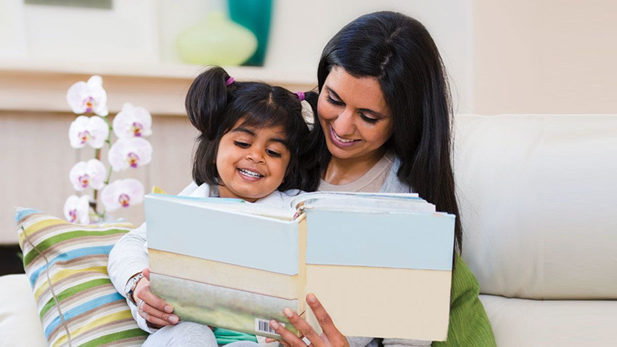 Mother and daughter read Bright Horizons Growing Readers early childhood educational books