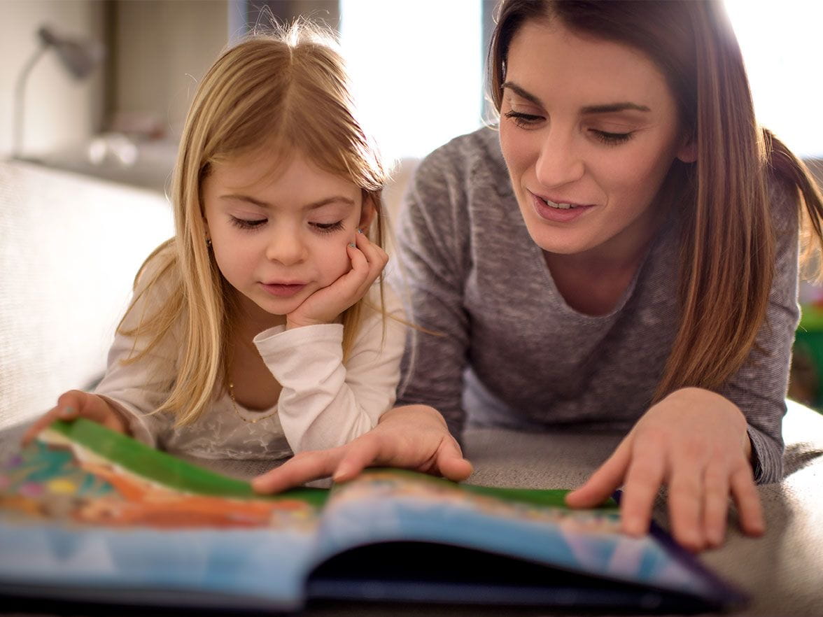 Mother and daughter read together and discover educational elements of growing readers
