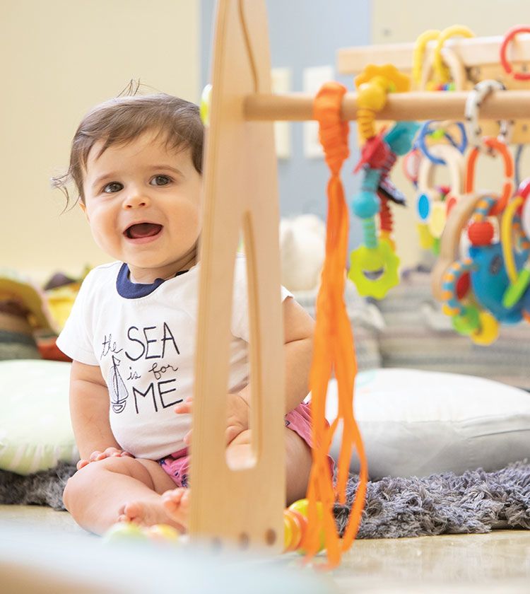 Baby at daycare in the infant classroom at Bright Horizons