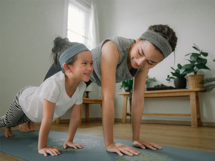 Mother and daughter practice mindfulness and yoga together