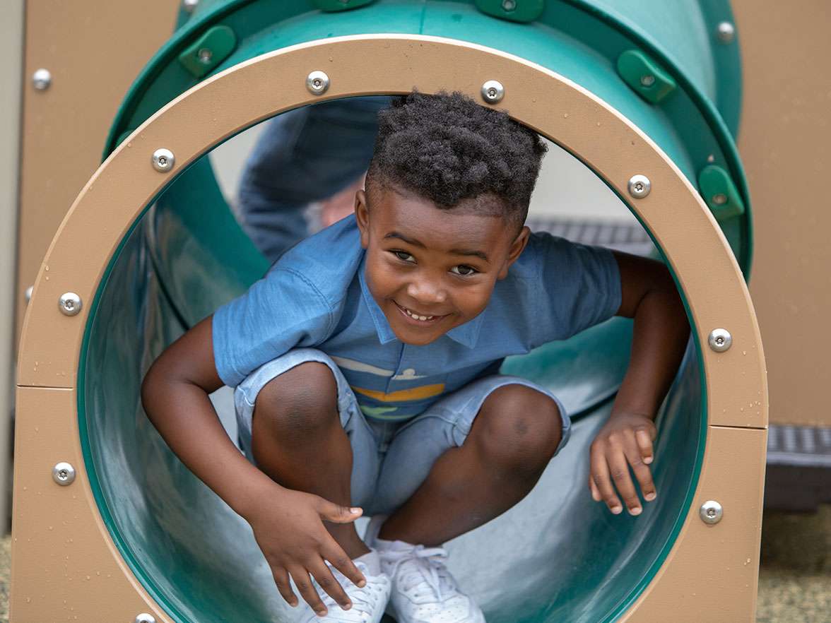 preschool boy climbing in a playground