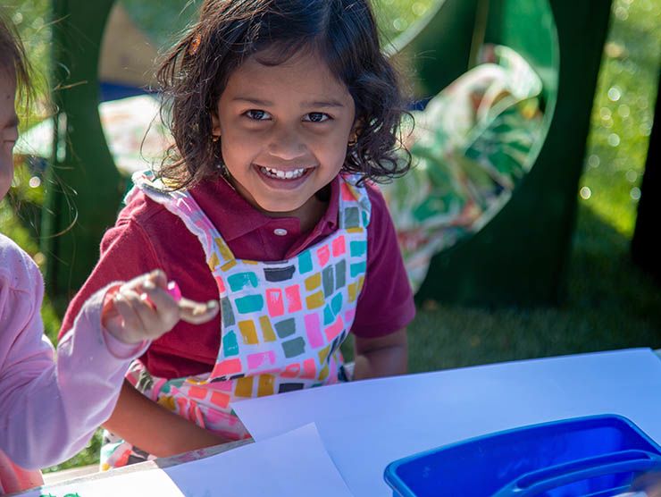 Little girl sitting at table