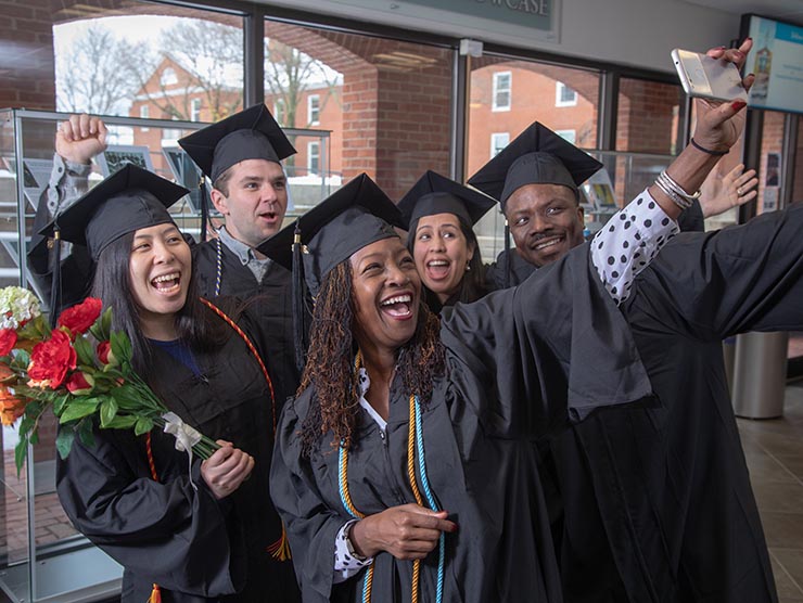 Students celebrating graduation taking a selfie