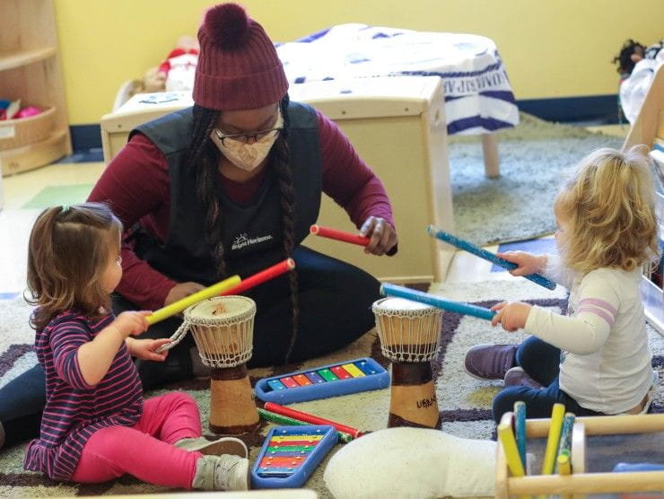 teacher playing drums with kids