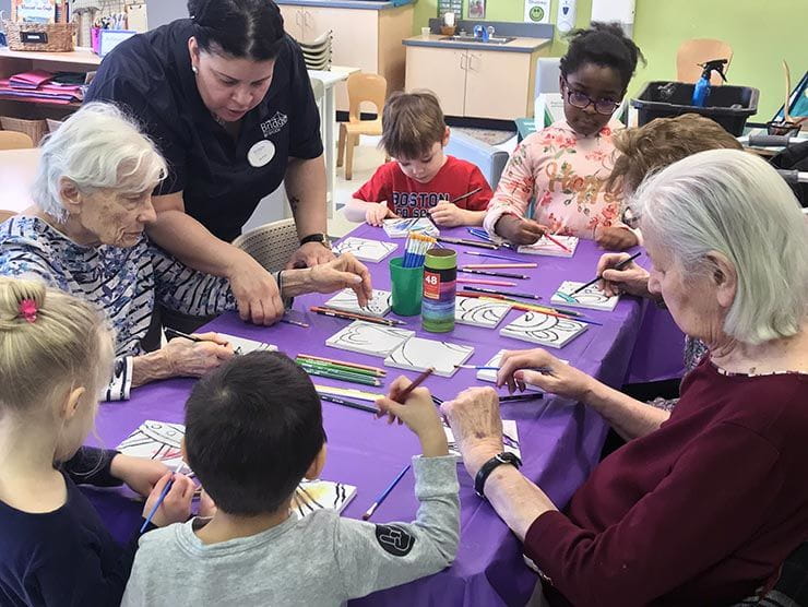 Children and seniors making art together