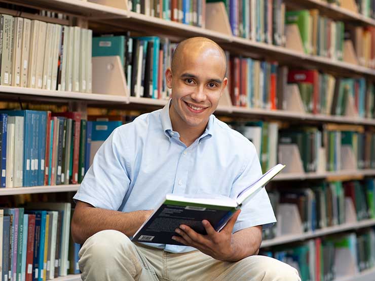 Adult male studying in library