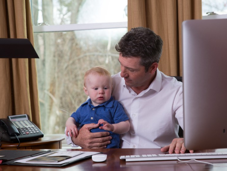 father sitting with child at desk 