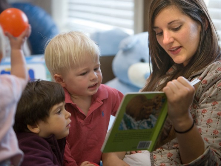 teacher reading books to children 