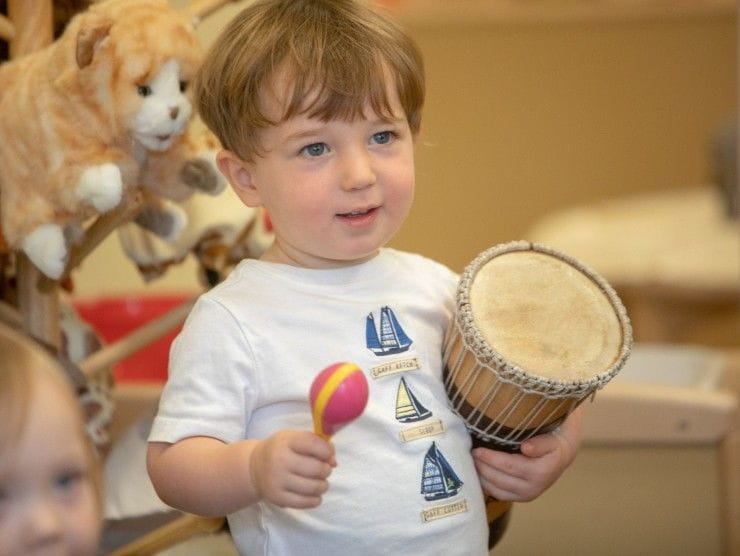 child holding musical instrument 