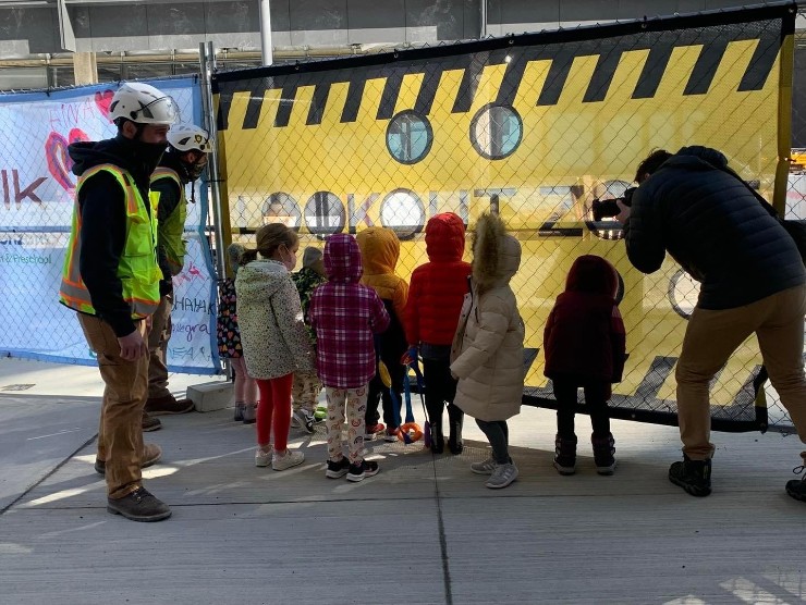 children looking at construction site 