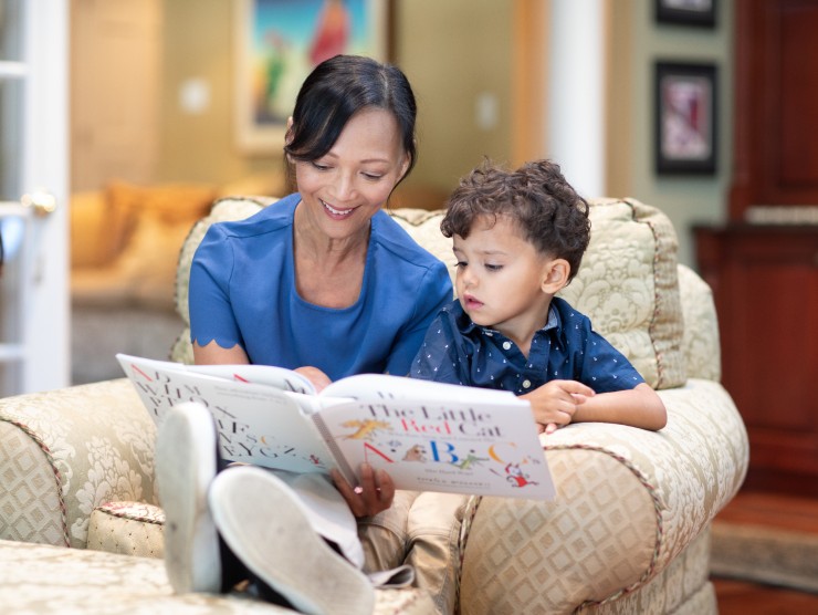 babysitter and child read book 