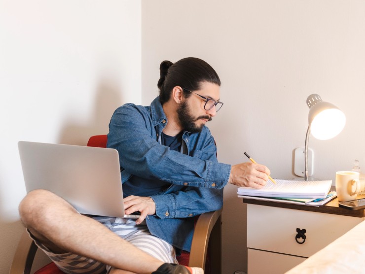 man sitting on chair with laptop