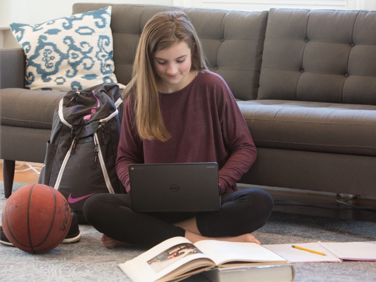high school student sitting with laptop 