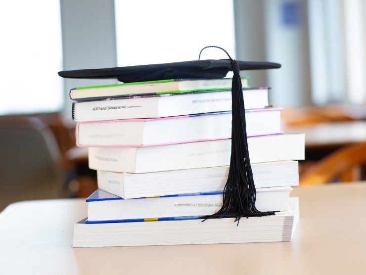 books with graduation cap 
