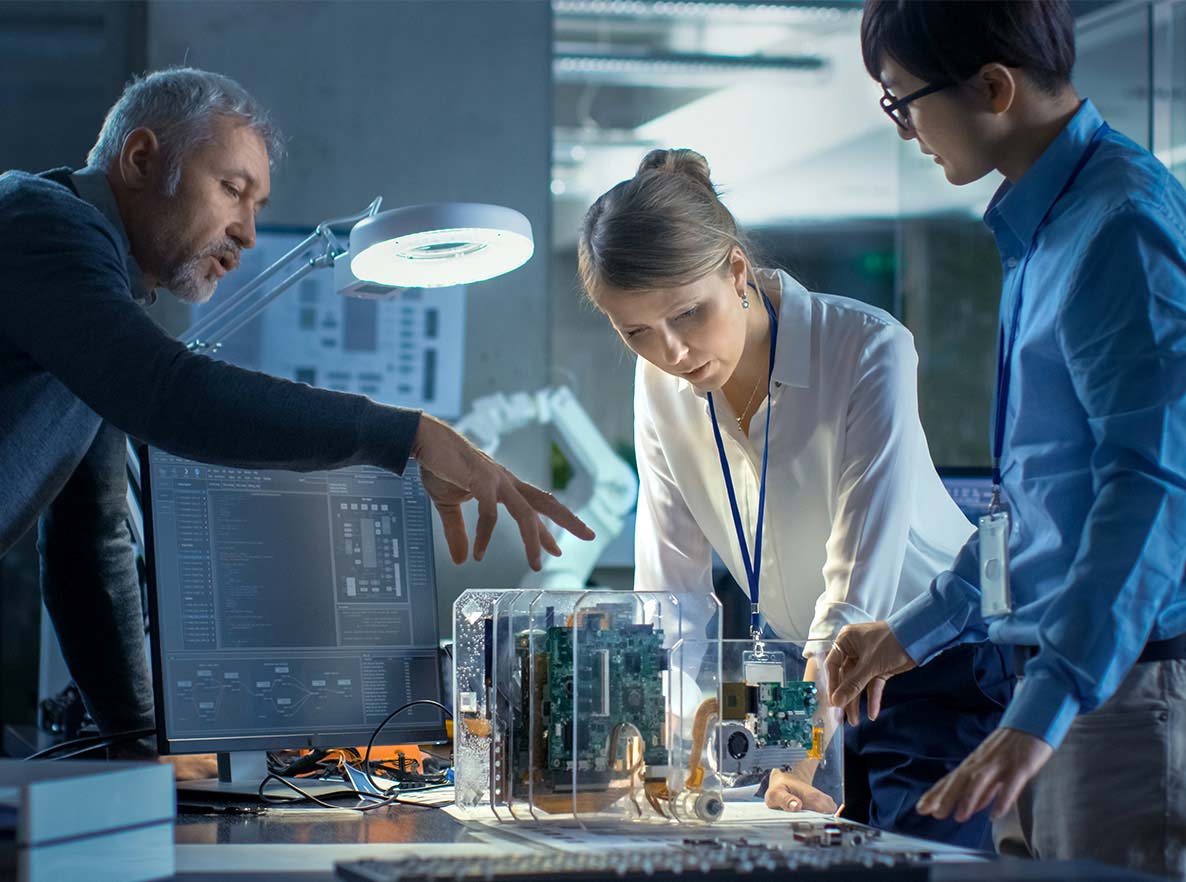 workers designing computer hovering over parts in office