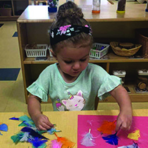 Young girl doing an art project at daycare