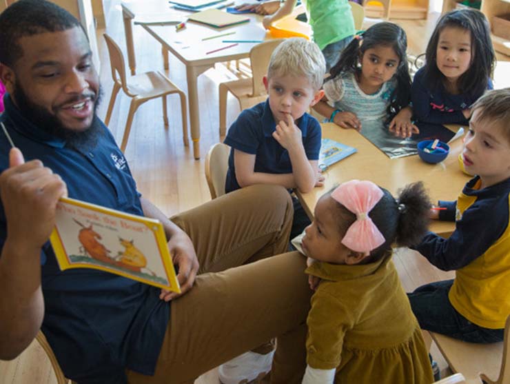 preschool teacher reading at daycare near home