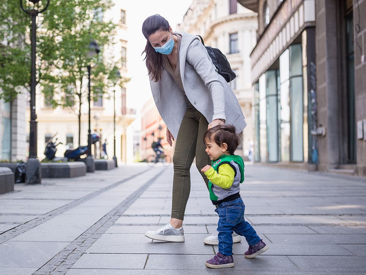 mother with toddler walking outside