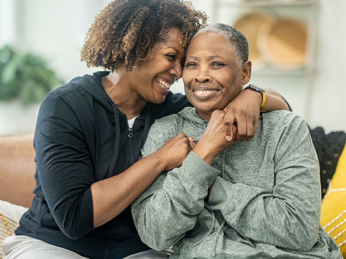Mother hugging aging parent