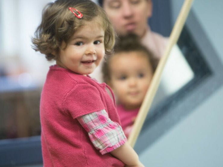 Toddlers using mirrors to look at their reflection