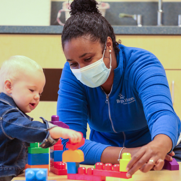 teacher with infant playing