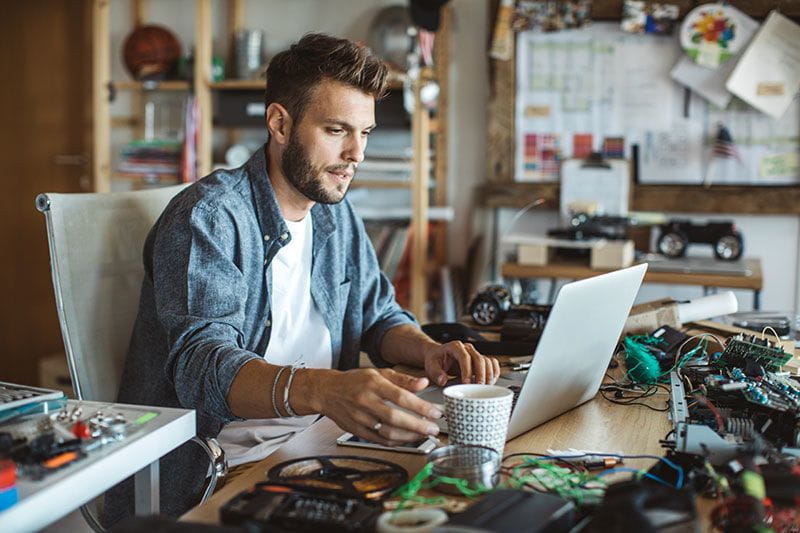 Man using his humanities degree to work with AI machines