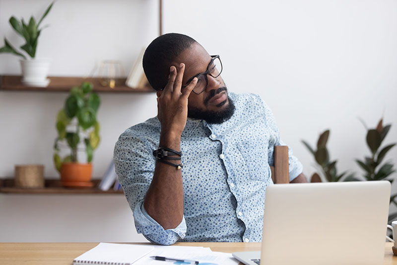 Employee looking stressed working from home