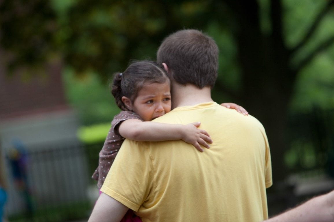 Small child being carried by father
