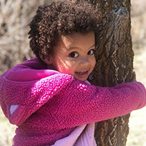 girl hugging a tree