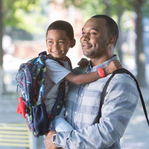 Black man holding child