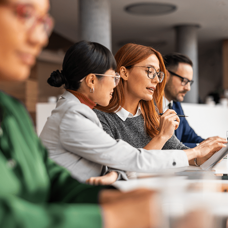 Employees sitting at a table collaborating