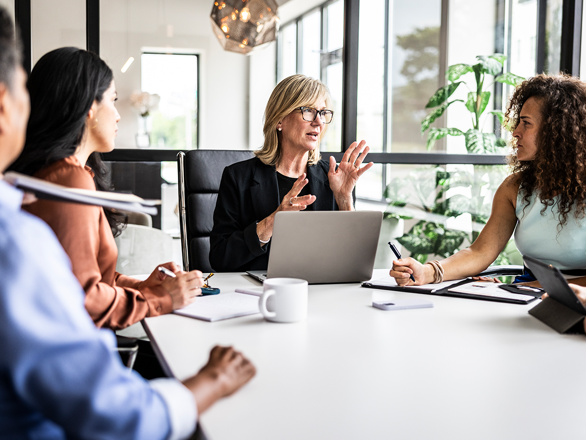 Employees sitting at an office table collaborating