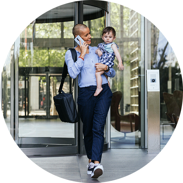 Parent carrying child and talking on the phone