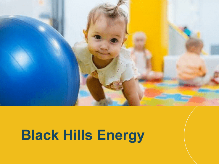 Black Hills Energy with baby with a ball crawling towards camera