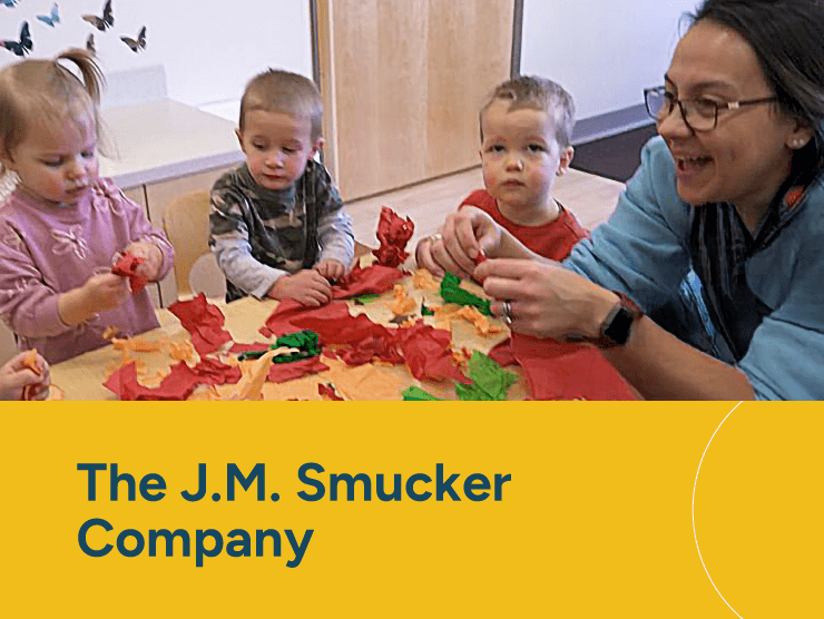 Smucker's with children playing at a table with a teacher