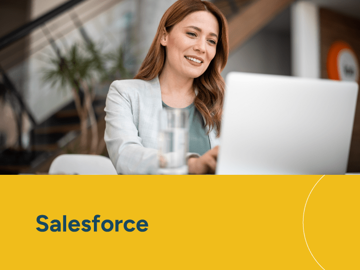 Salesforce with a woman working on a laptop