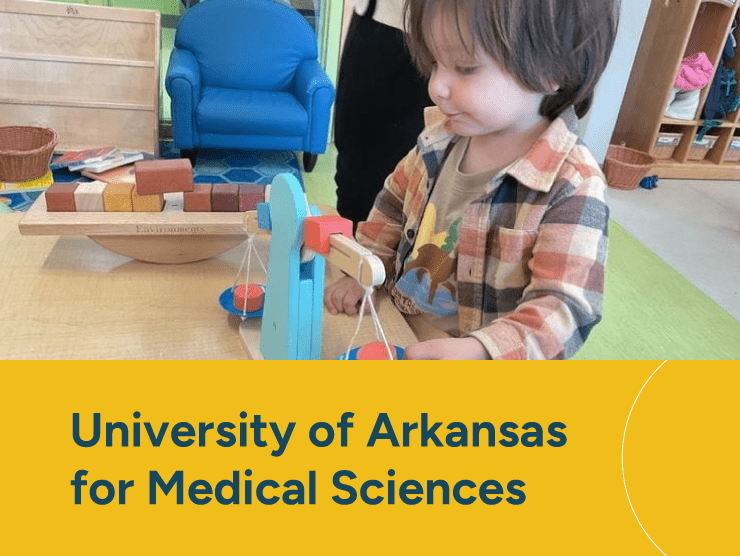 UAMS with child playing at a center