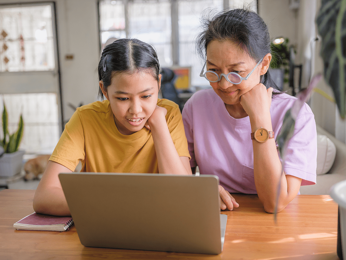 Mother and daughter looking at a laptop together