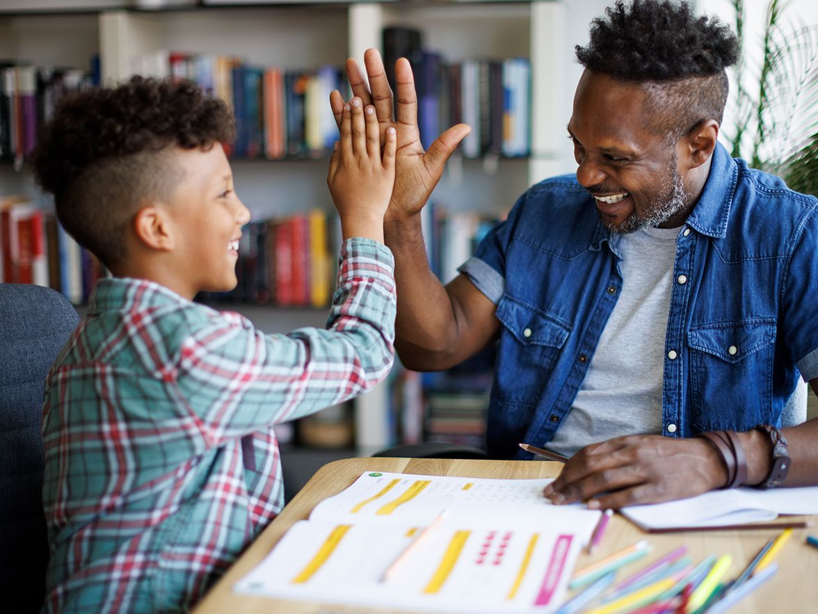 Father and son high fiving and smiling