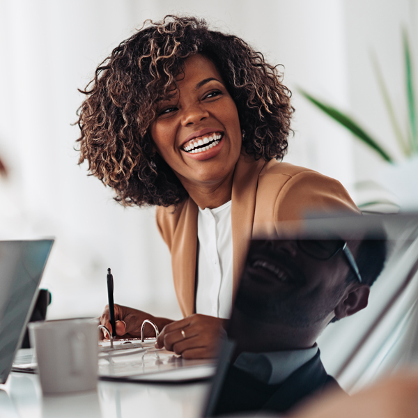 women smiling at desk