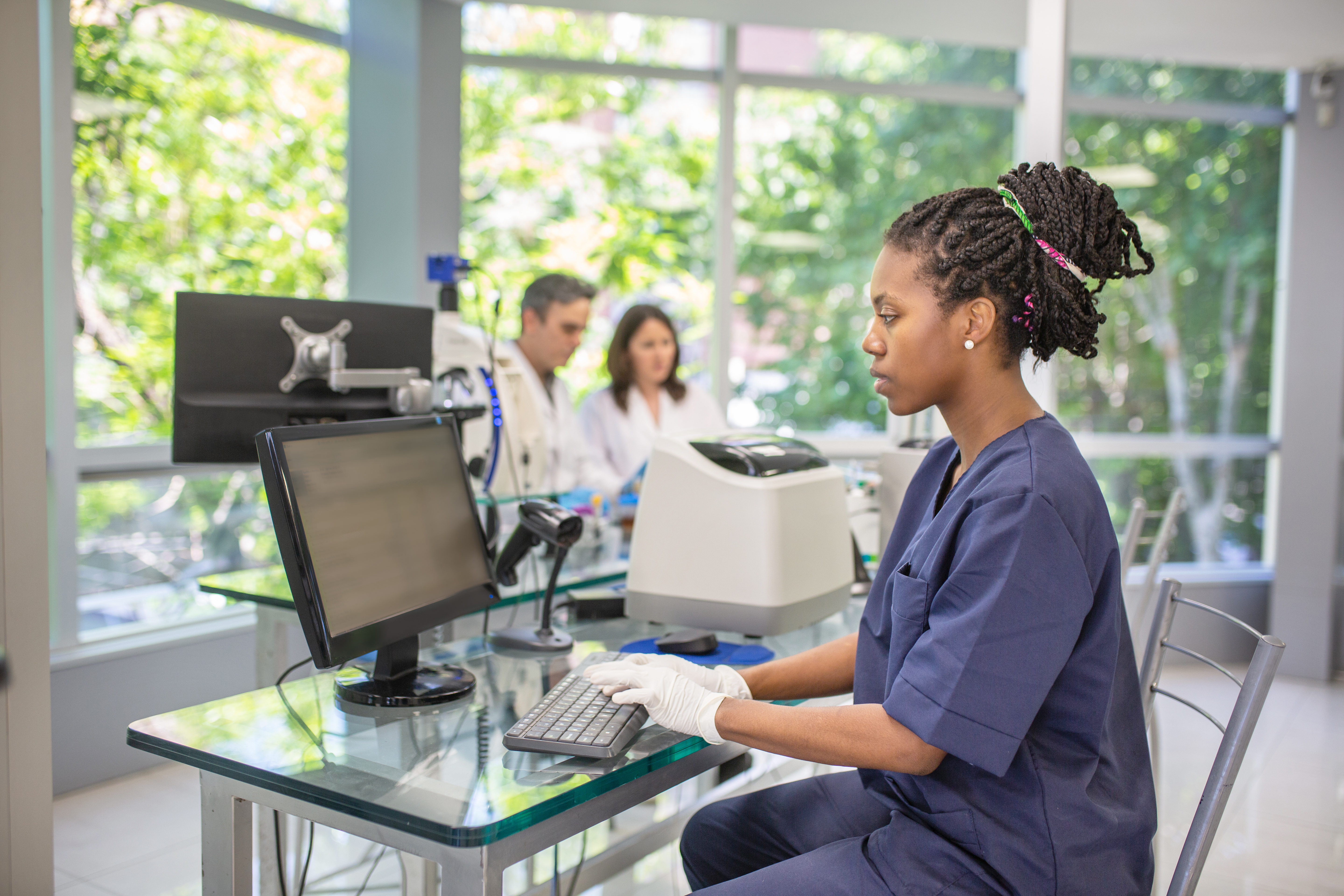 woman typing at computer screen