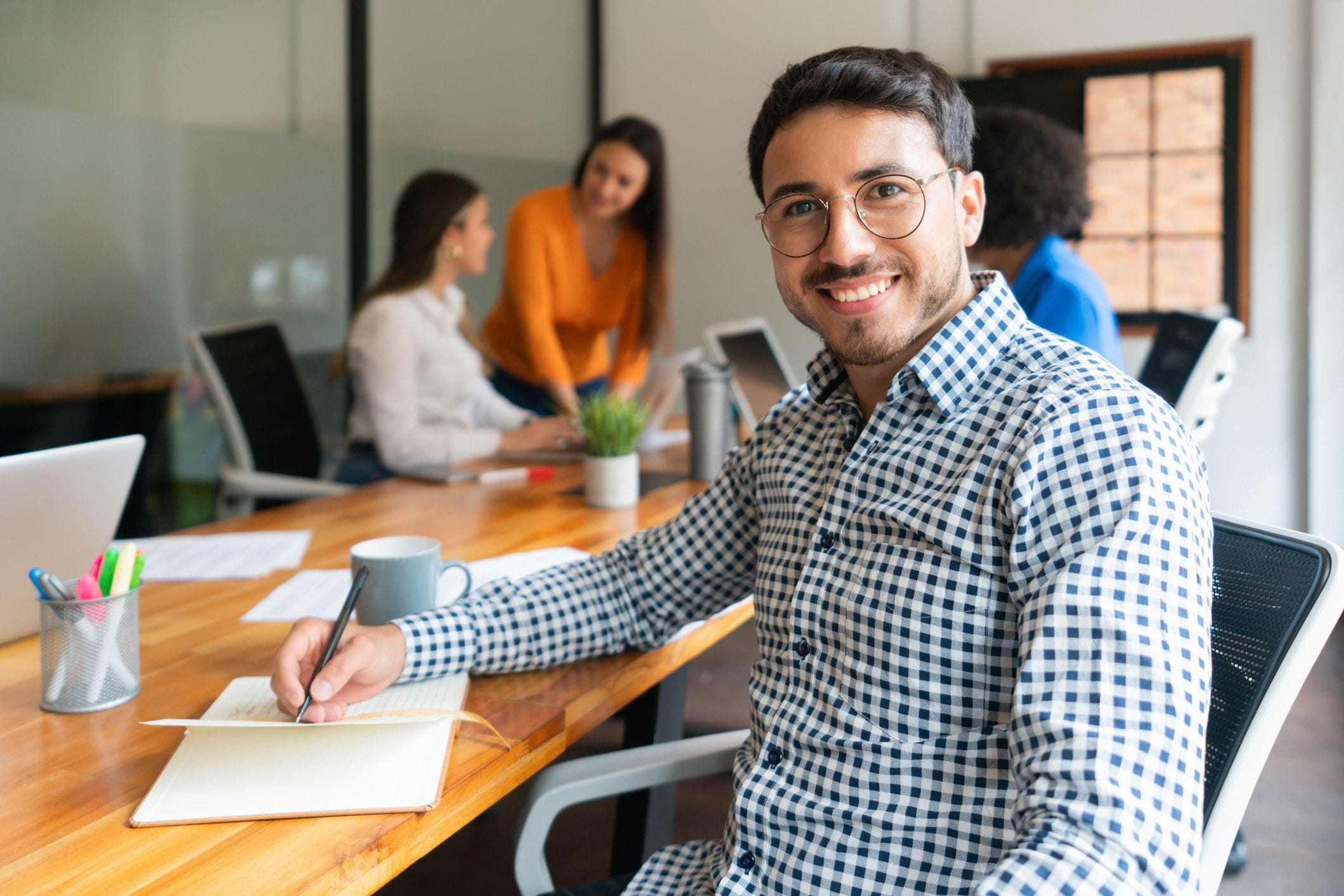 Smiling man sitting in conference room 